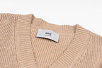 Beige knit V-neck sweater with ribbed collar and Ami label at neckline