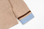 Beige knit sweater sleeve cuff with blue stripe and brown border
