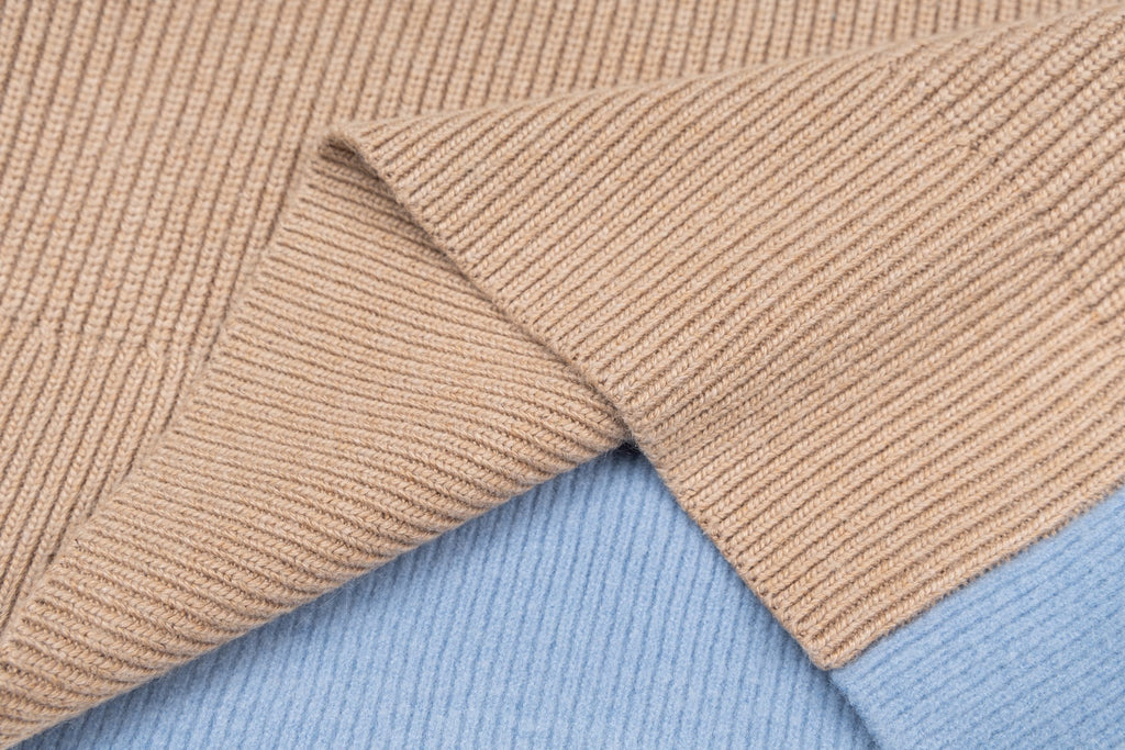Beige ribbed knit sweater sleeve and cuff