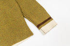 Knit sweater sleeves and hem with brown-and-white stripe accents