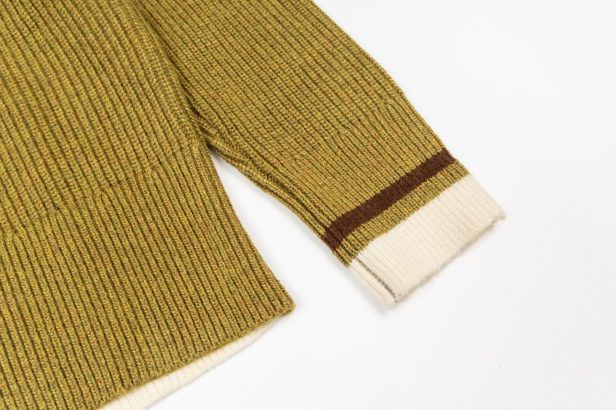 Knit sweater sleeves and hem with brown-and-white stripe accents