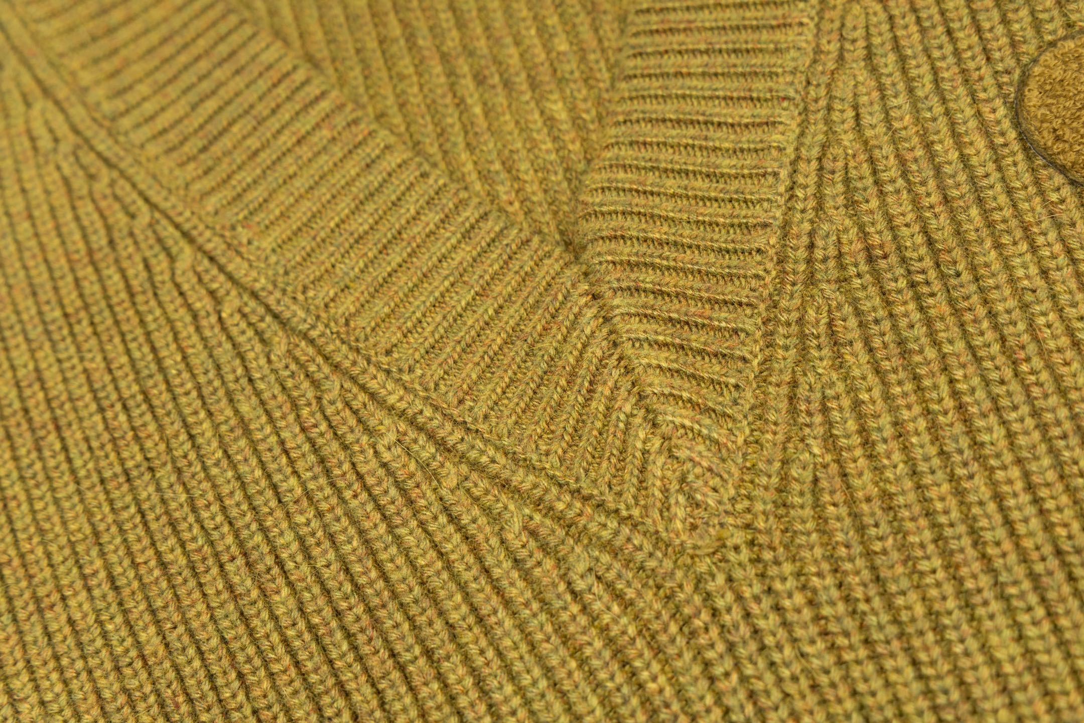 V-neck knit sweater fabric close-up with textured rib knit pattern