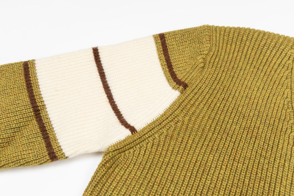 Knit sweater shoulder and striped sleeve cuff detail