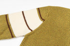 Knit sweater shoulder and striped sleeve cuff detail