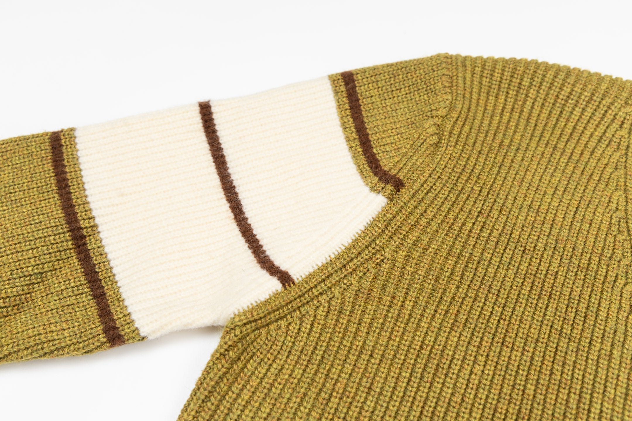 Knit sweater shoulder and striped sleeve cuff detail