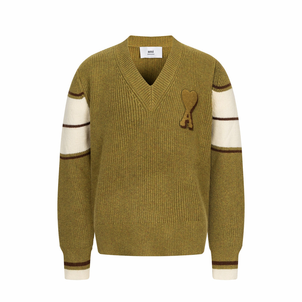 V-neck knit sweater with long sleeves, striped cuffs, and A heart applique on chest