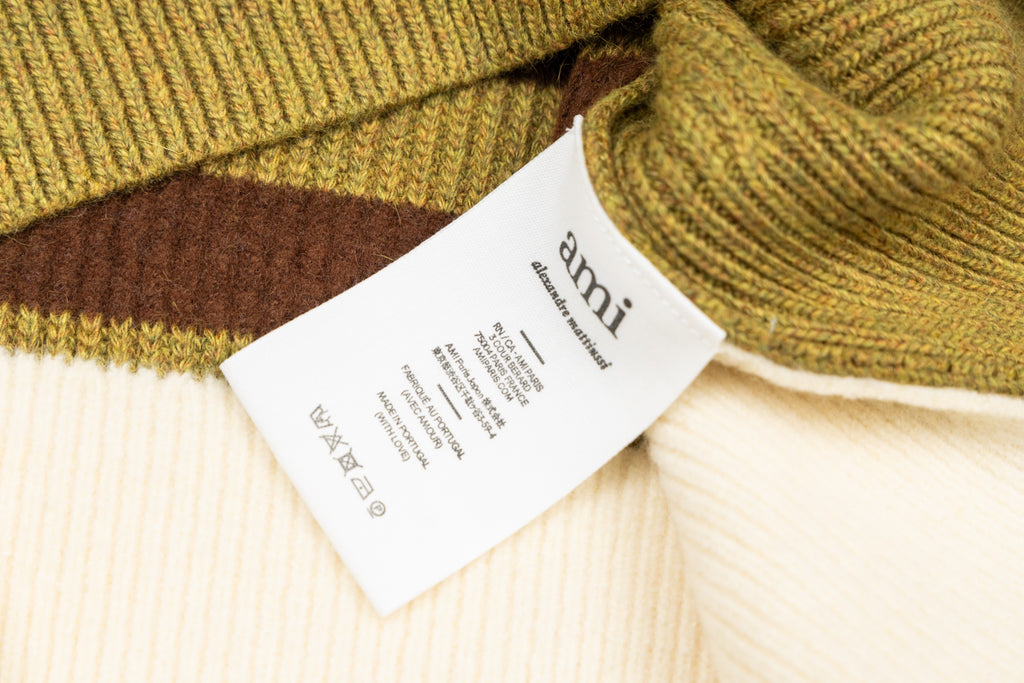 Amiri knit sweater with woven tag and brown stripe trim at hem