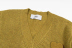 V-neck knit sweater close-up with ribbed trim and A heart applique