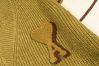 A heart applique detail on knit sweater front
