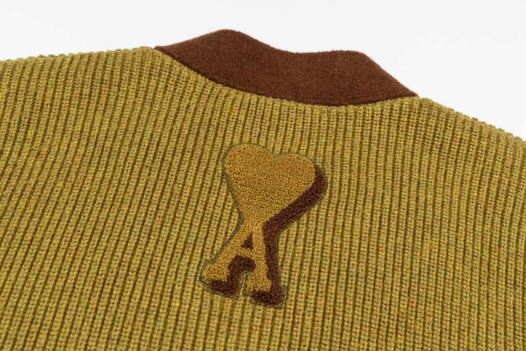 Olive knit cardigan shoulder with embroidered bone logo on brown trim