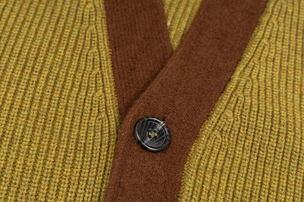 Brown button placket with four dark metal buttons on olive knit cardigan