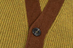 Brown button placket with four dark metal buttons on olive knit cardigan