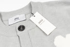 Light gray knit cardigan with button front, ribbed collar, and hang tag