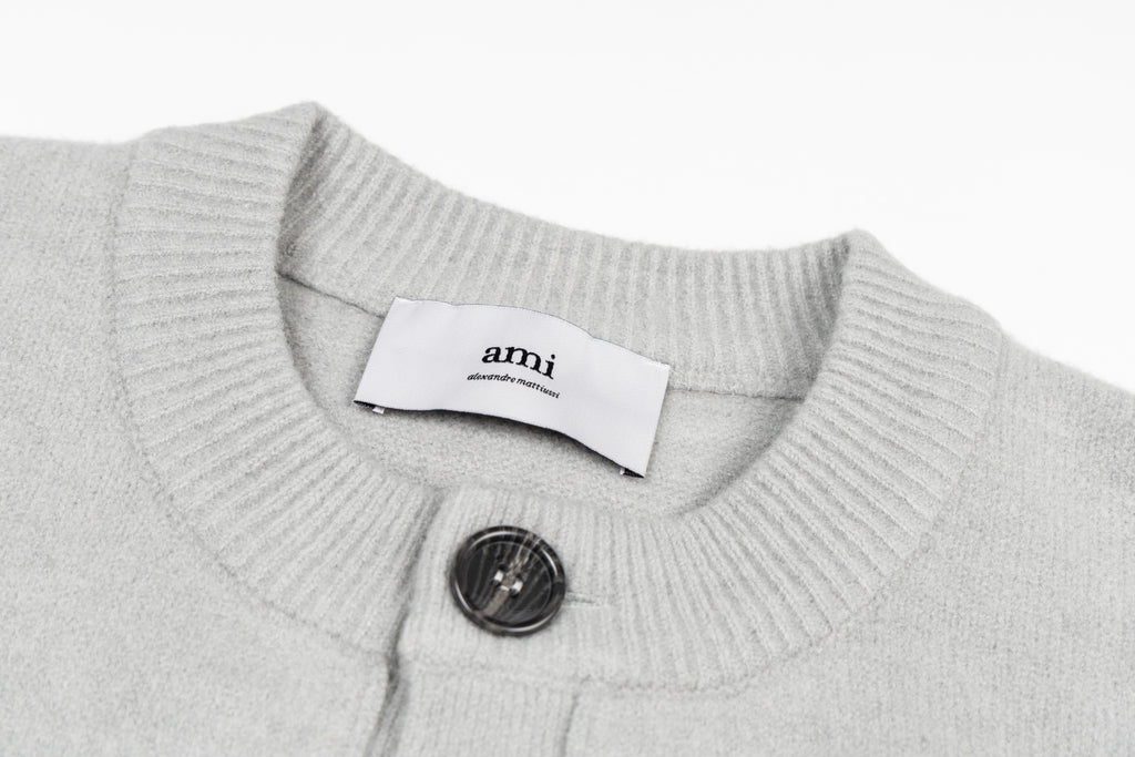 Light gray knit collar with button placket and interior brand label