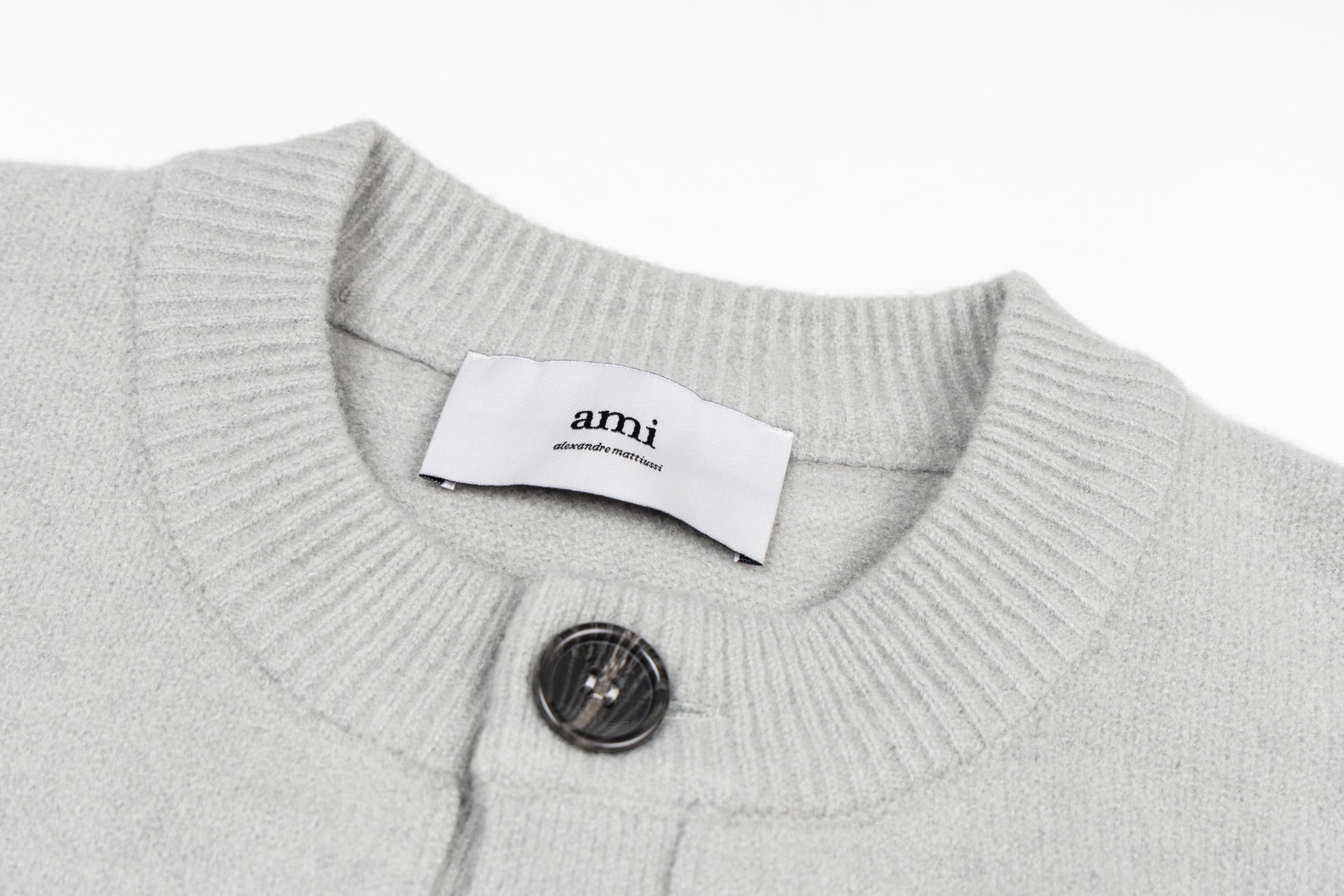 Light gray knit collar with button placket and interior brand label