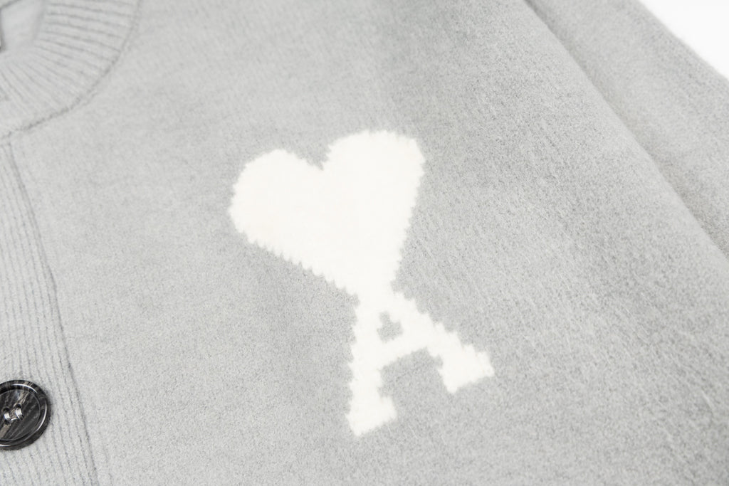 Light gray knit cardigan with close-up white heart graphic
