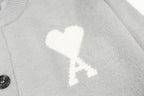 Light gray knit cardigan with close-up white heart graphic