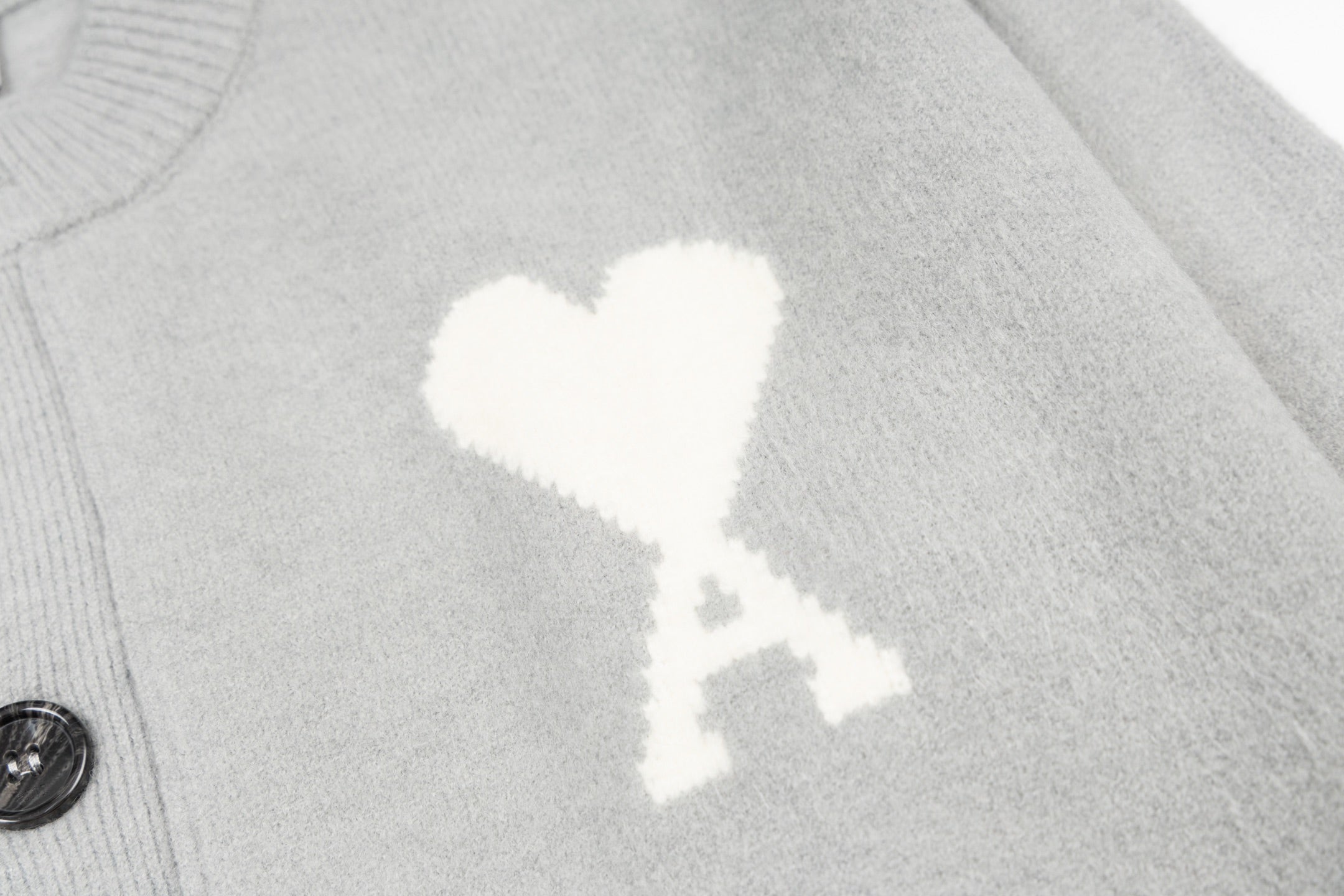 Light gray knit cardigan with close-up white heart graphic