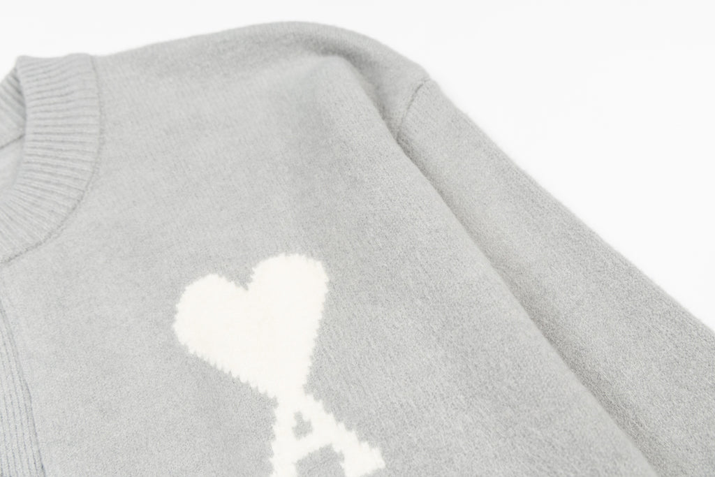 Light gray knit cardigan with large white heart graphic on chest