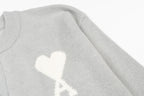 Light gray knit cardigan with large white heart graphic on chest