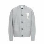 Light gray knit cardigan with button front and white heart logo with letter A