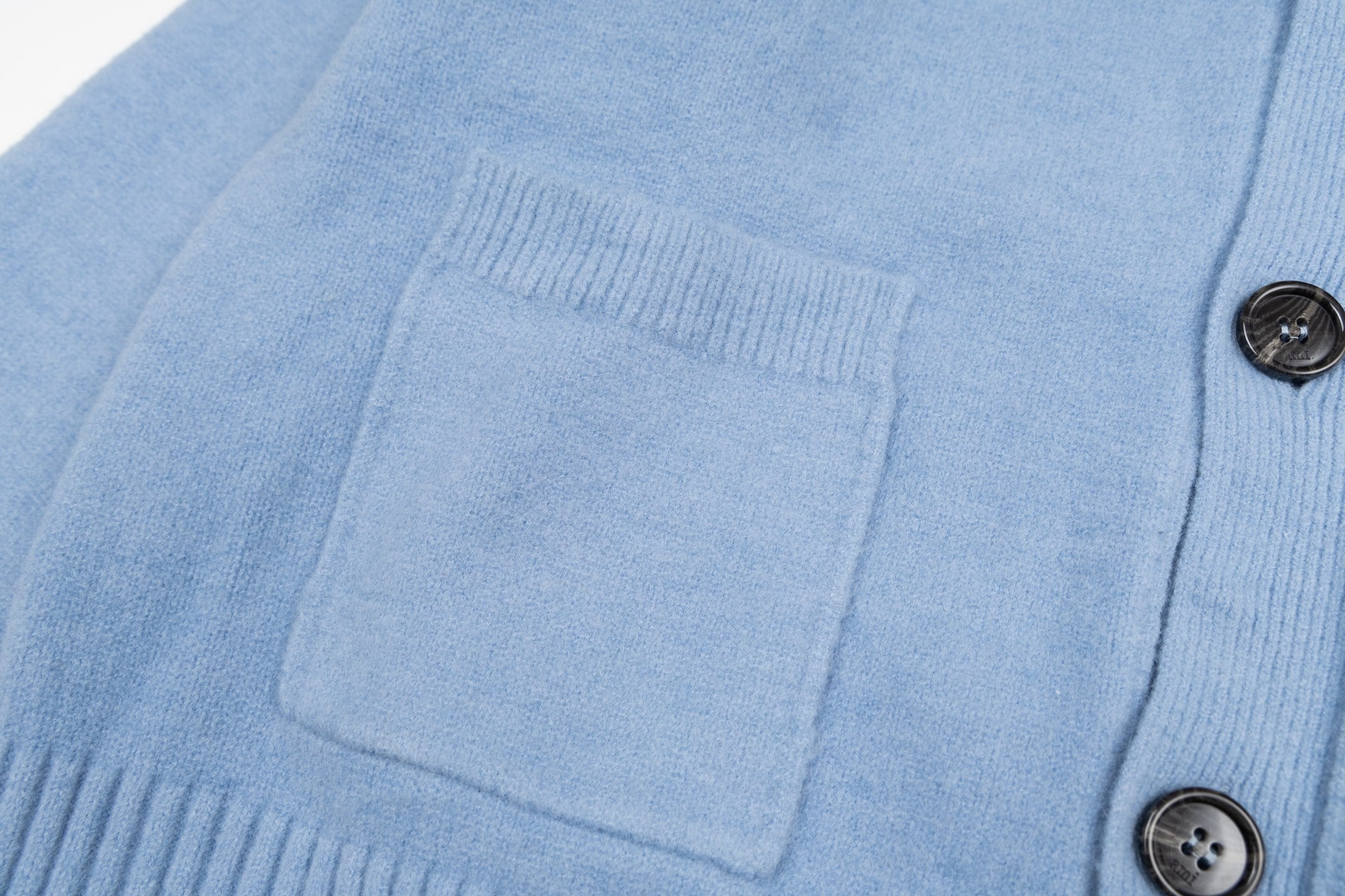 Amiri light blue knit cardigan front with patch pockets and black buttons