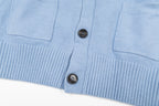 Amiri light blue knit cardigan front hem with buttons and patch pockets close-up