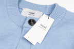 Amiri light blue knit cardigan with button placket, brand labels, and neck opening