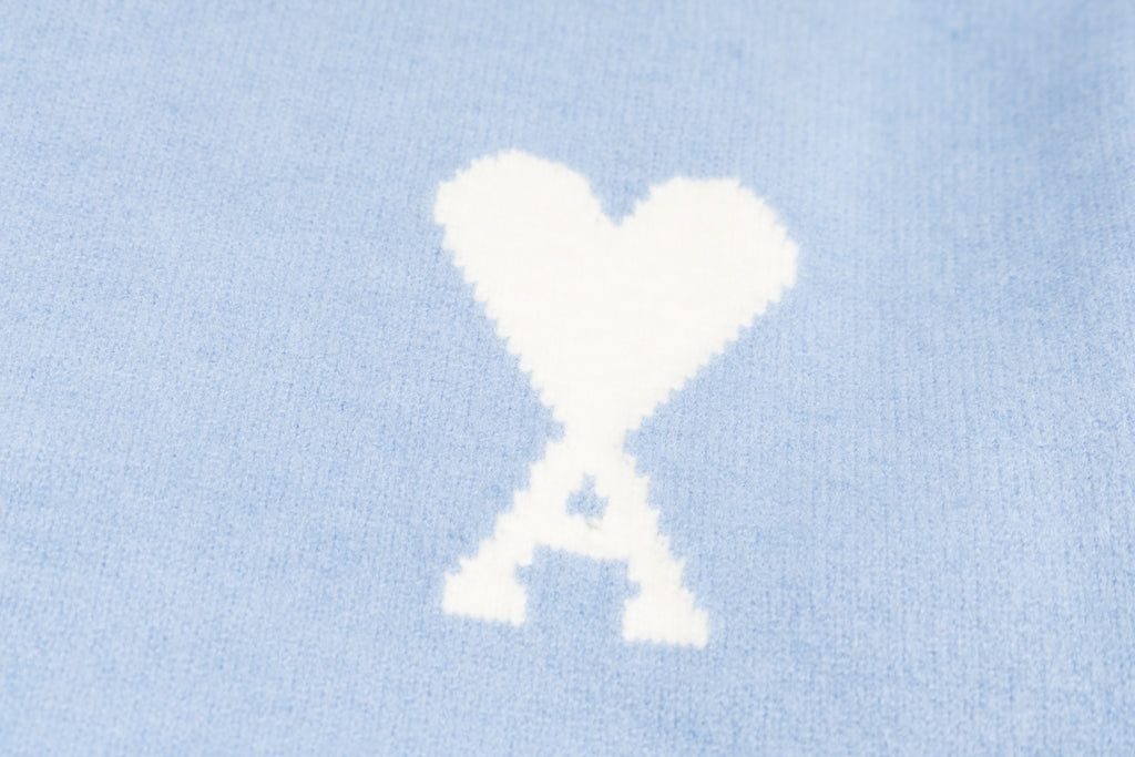Amiri light blue sweater with white heart-and-X emblem