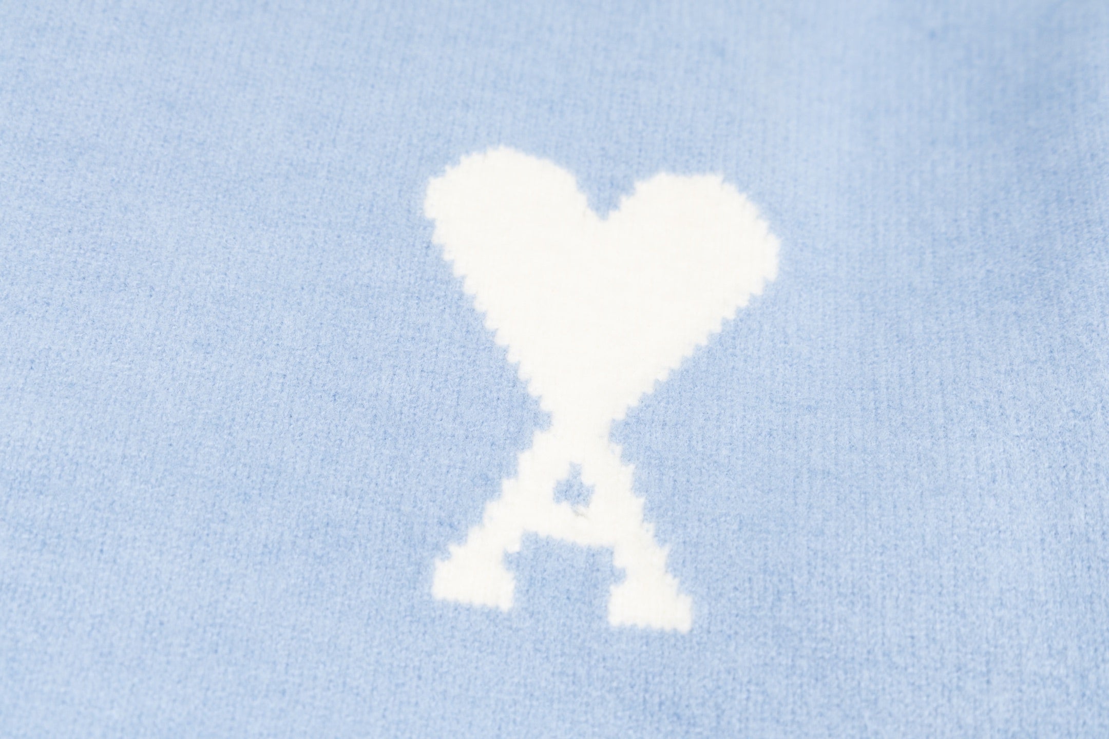 Amiri light blue sweater with white heart-and-X emblem