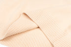 Light pink knit sweater with ribbed panel detailing near the shoulder
