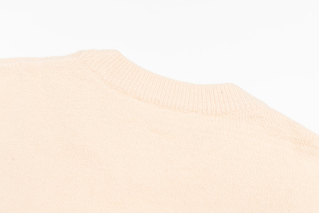 Light pink sweater knit with ribbed crew neckline detail