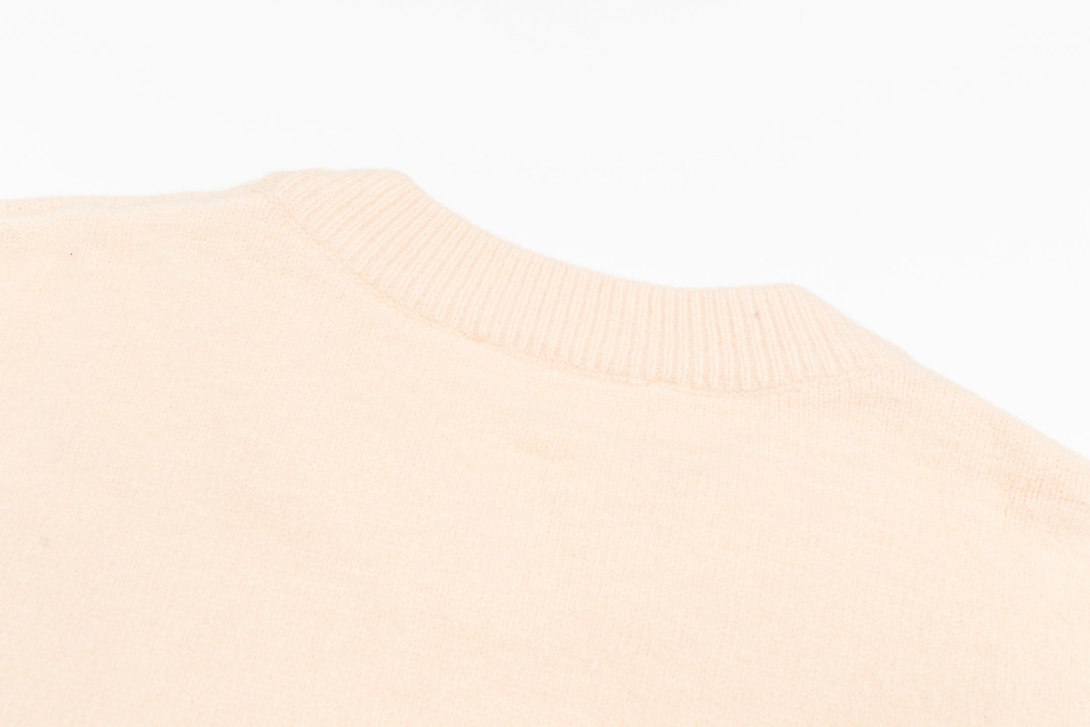 Light pink sweater knit with ribbed crew neckline detail
