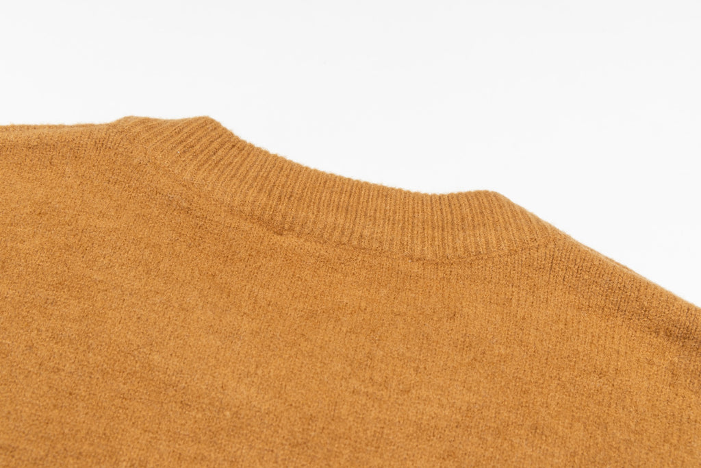 Camel brown crewneck sweater with smooth knit texture