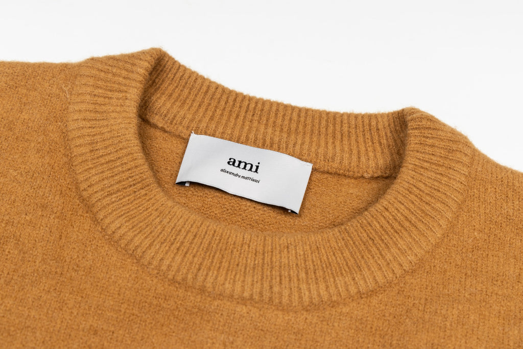 Camel brown crewneck sweater with ribbed collar and Amiri label