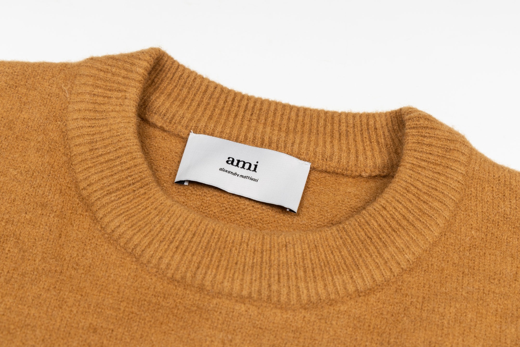 Camel brown crewneck sweater with ribbed collar and Amiri label