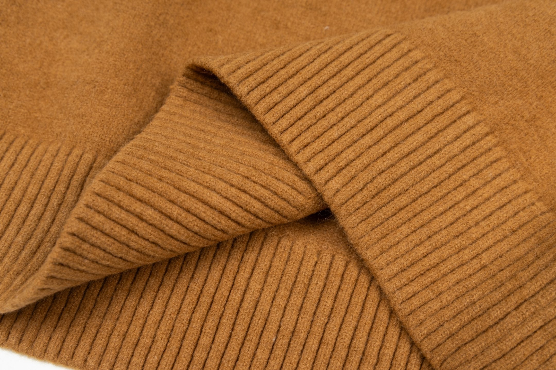 Camel brown sweater knit with ribbed cuff detail and layered fold