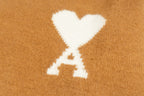Camel brown sweater with large white heart and X logo