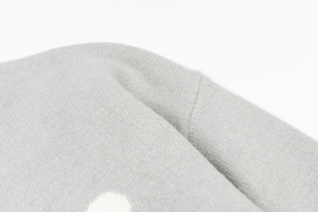 Amiri knit sweater sleeve cuff with soft light-gray knit texture