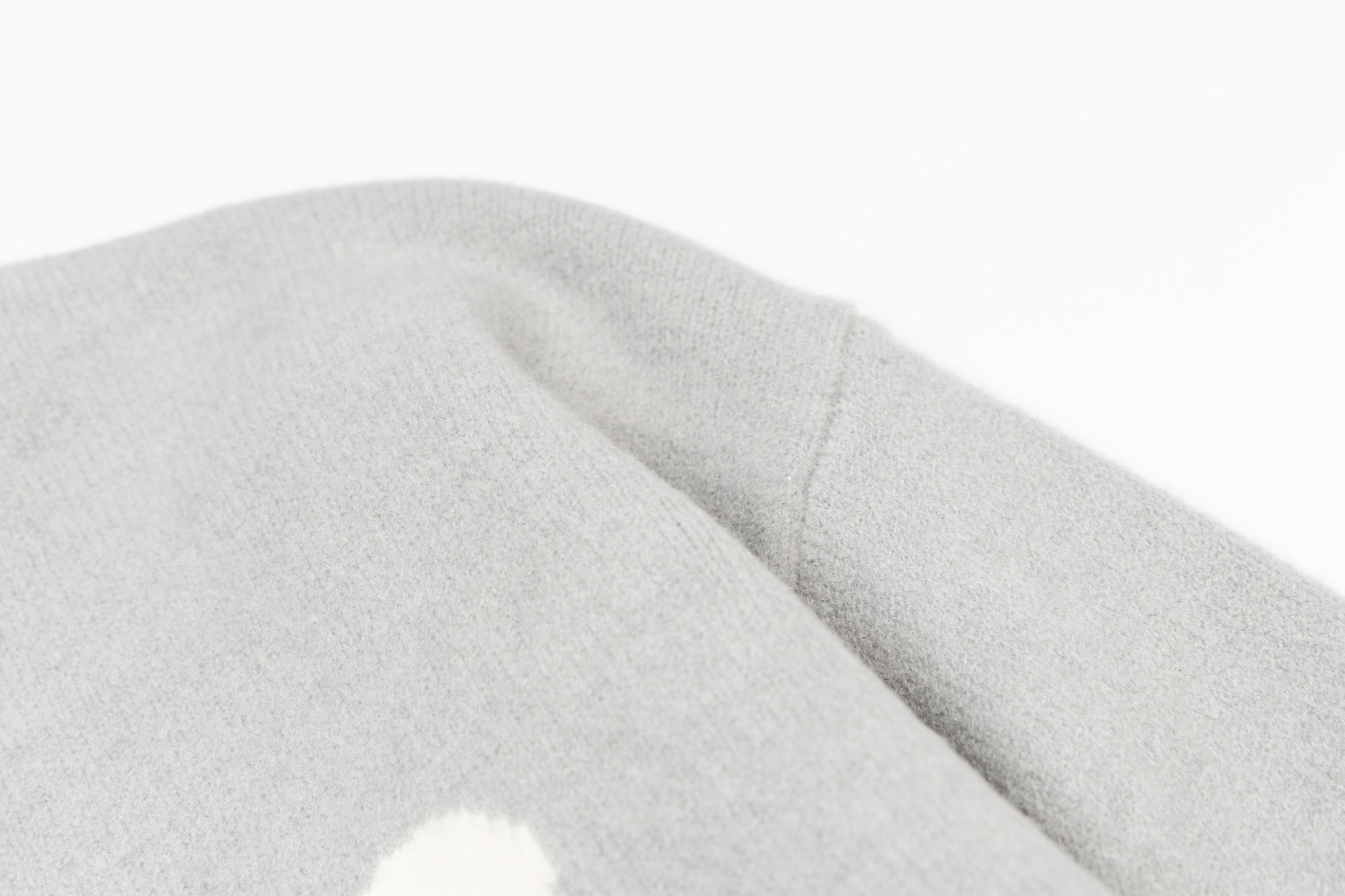 Amiri knit sweater sleeve cuff with soft light-gray knit texture