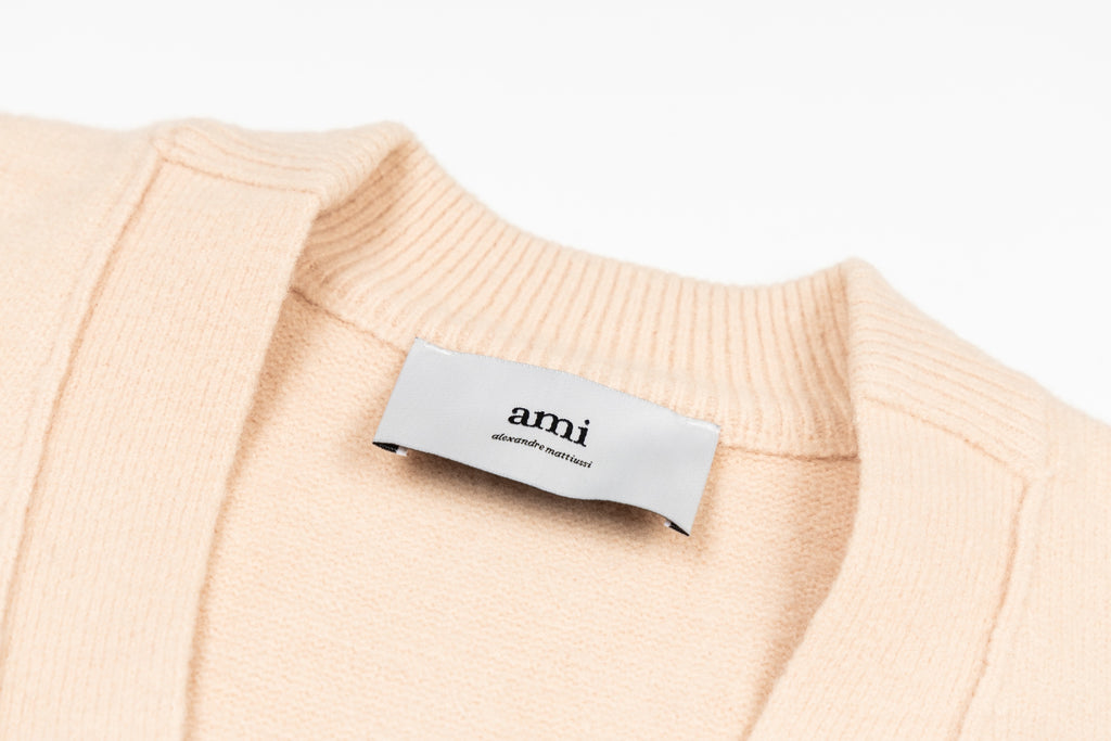 Amiri light peach knit cardigan neckline with interior brand label