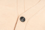 Amiri light peach knit cardigan with black button detail on button placket