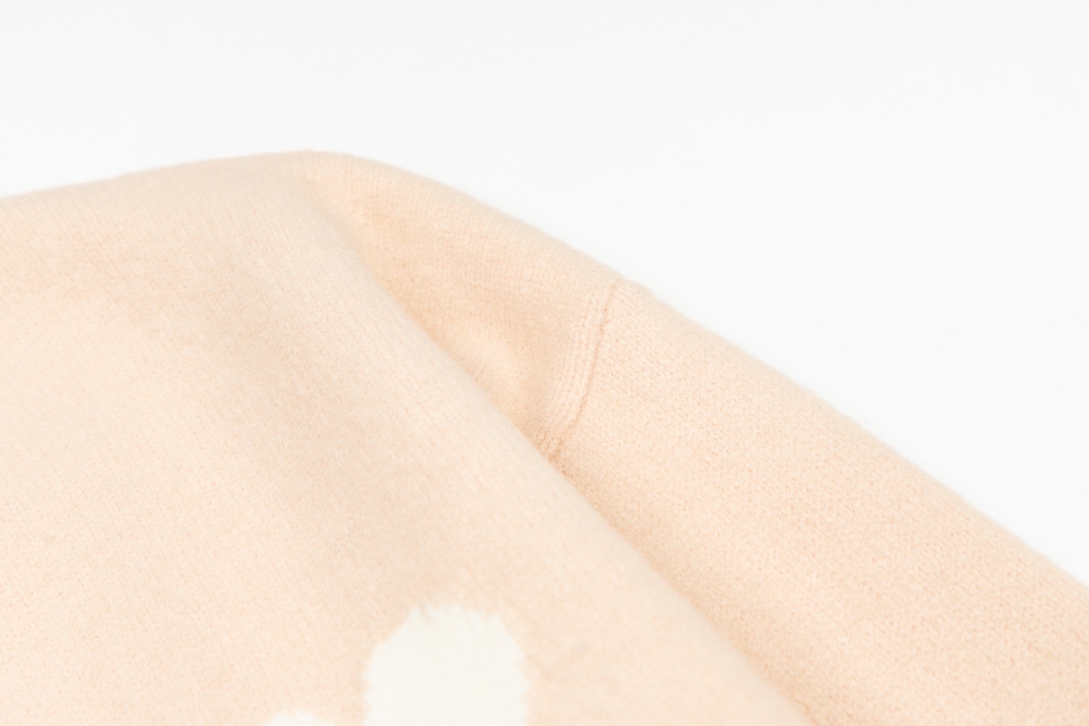 Amiri light peach knit sleeve with small white logo motif