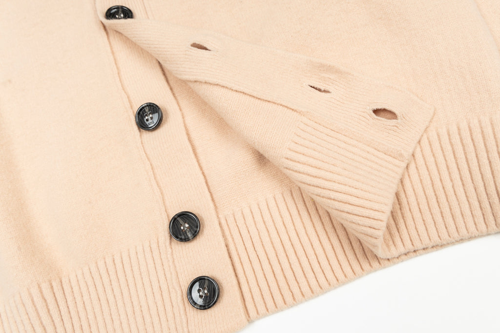 Cream knit cardigan with black buttons and ribbed trim