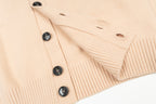 Cream knit cardigan with black buttons and ribbed trim