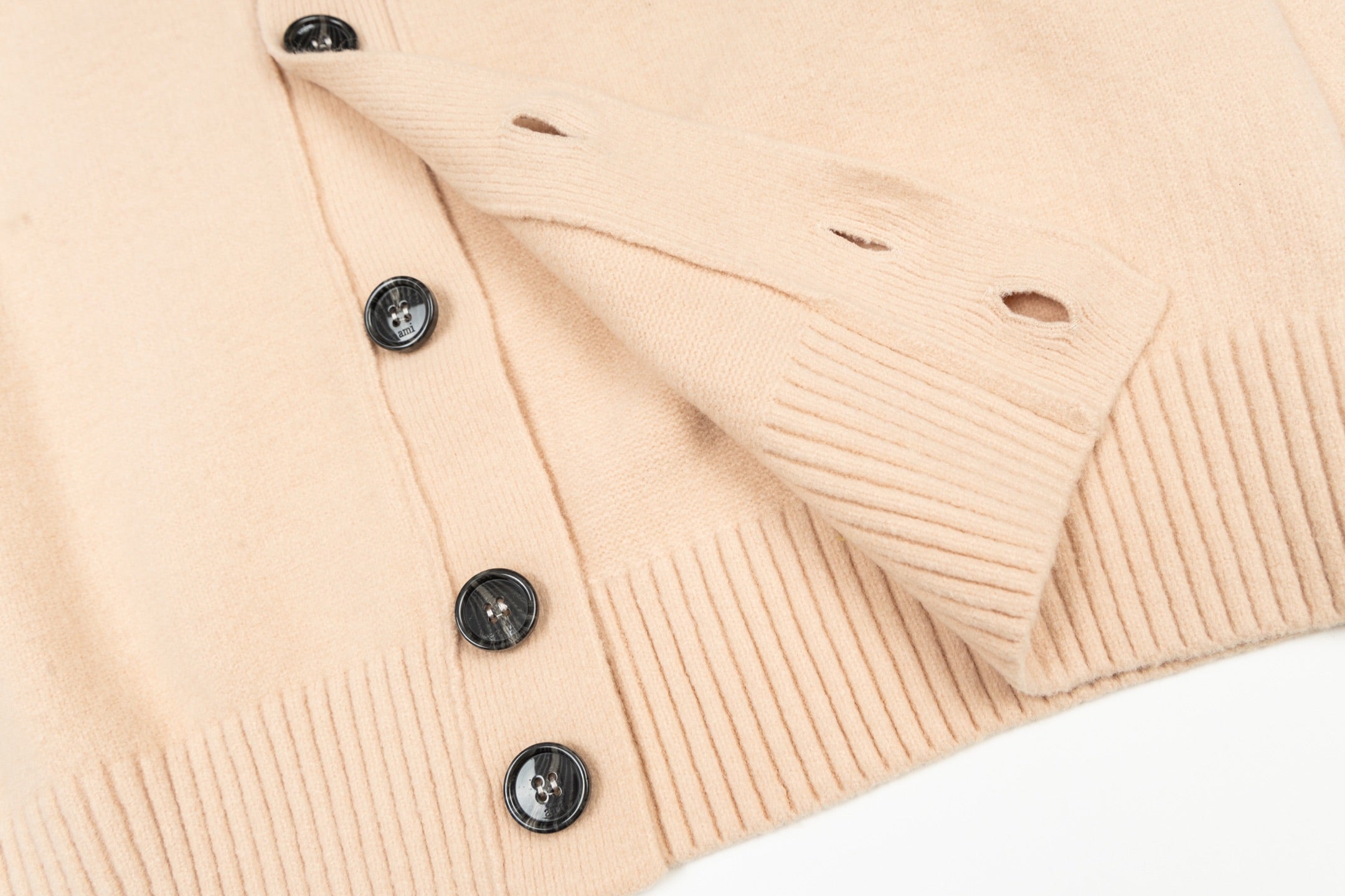 Cream knit cardigan with black buttons and ribbed trim