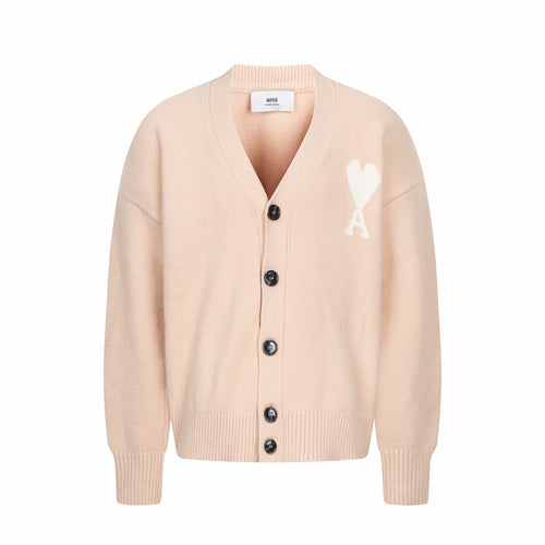 Amiri cardigan in light peach with V-neck, button placket, and A logo on chest