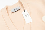 Amiri light peach cardigan collar with brand tags attached