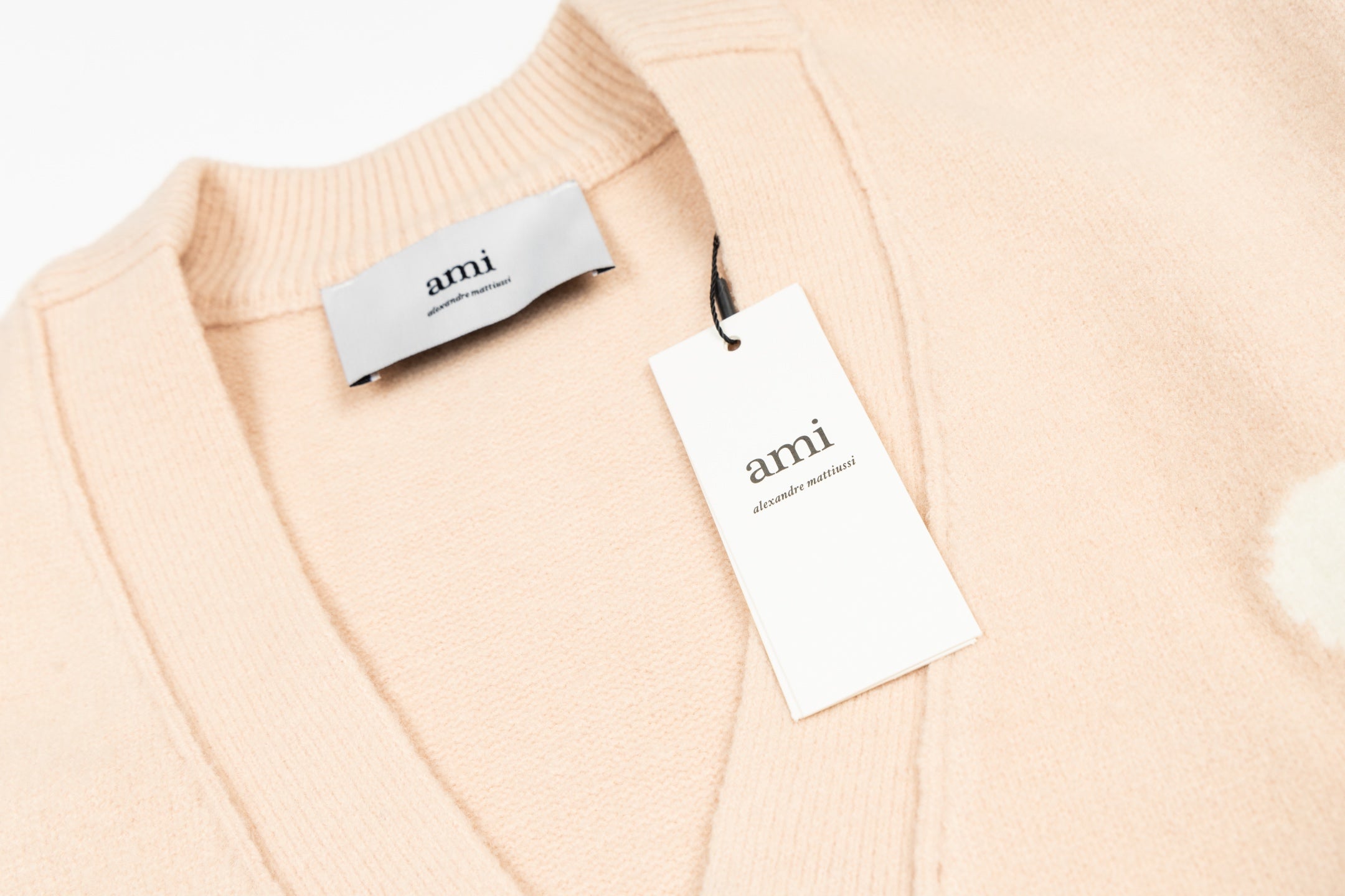 Amiri light peach cardigan collar with brand tags attached