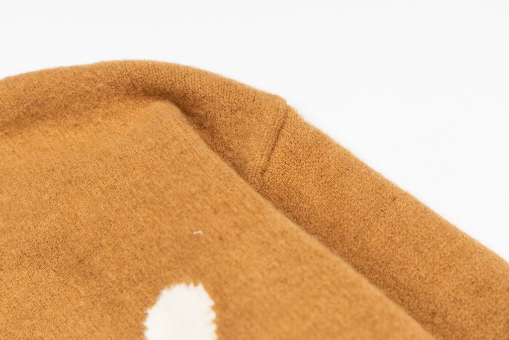 Tan knit cardigan collar and shoulder seam detail